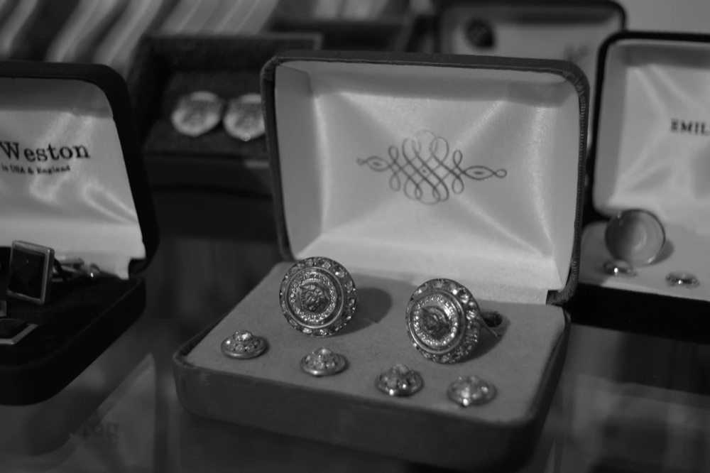 A pair of decorative cufflinks in a presentation box