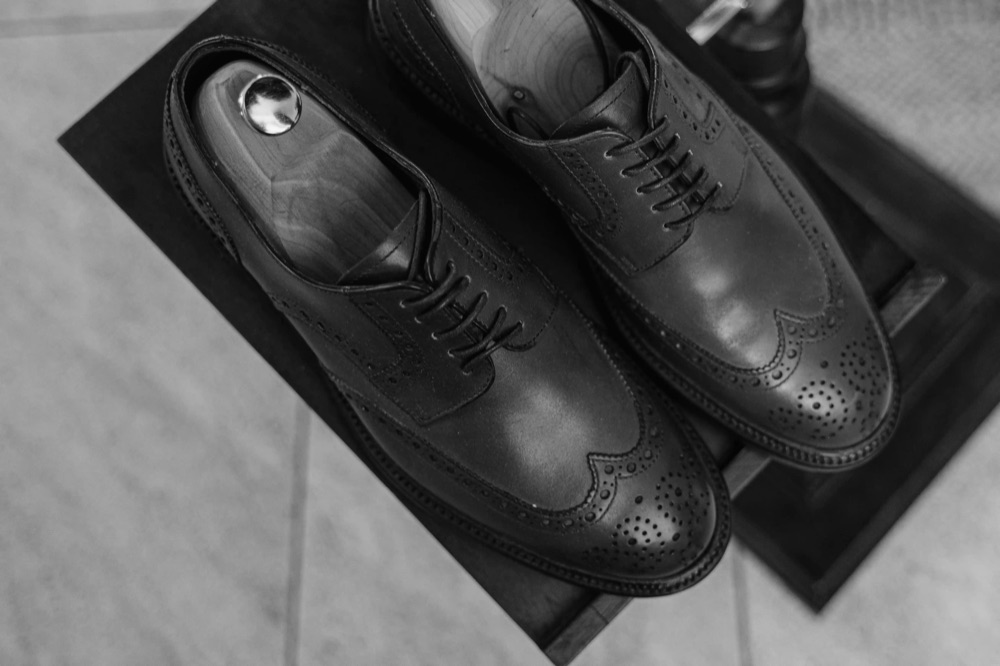 A pair of leather lace-up dress shoes